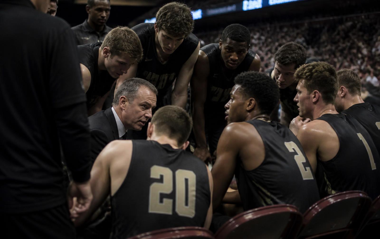 Competitive basketball team focused during an intense timeout
